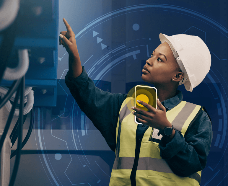 A woman in a white hard hat with an phone, checking equipment